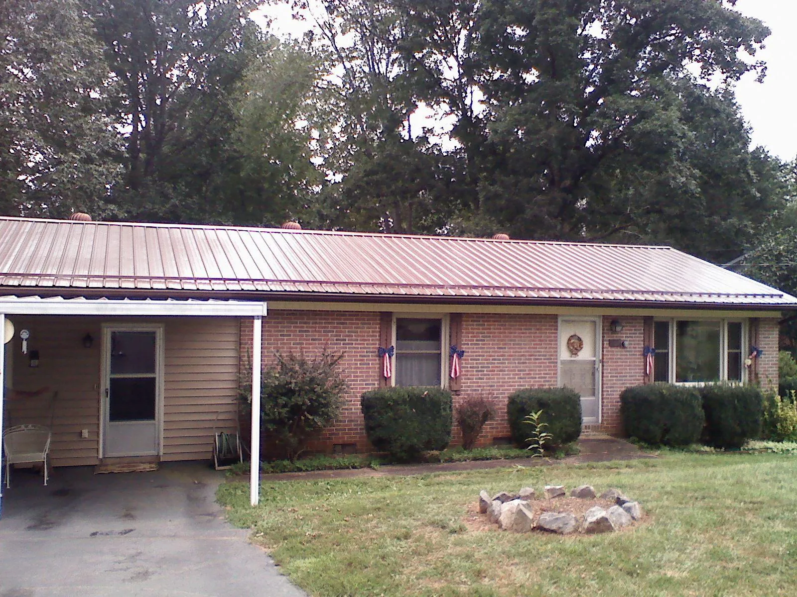 Bronze metal roof and carport on a brick ranch home — Roof Repair work by our crew in Hesperia