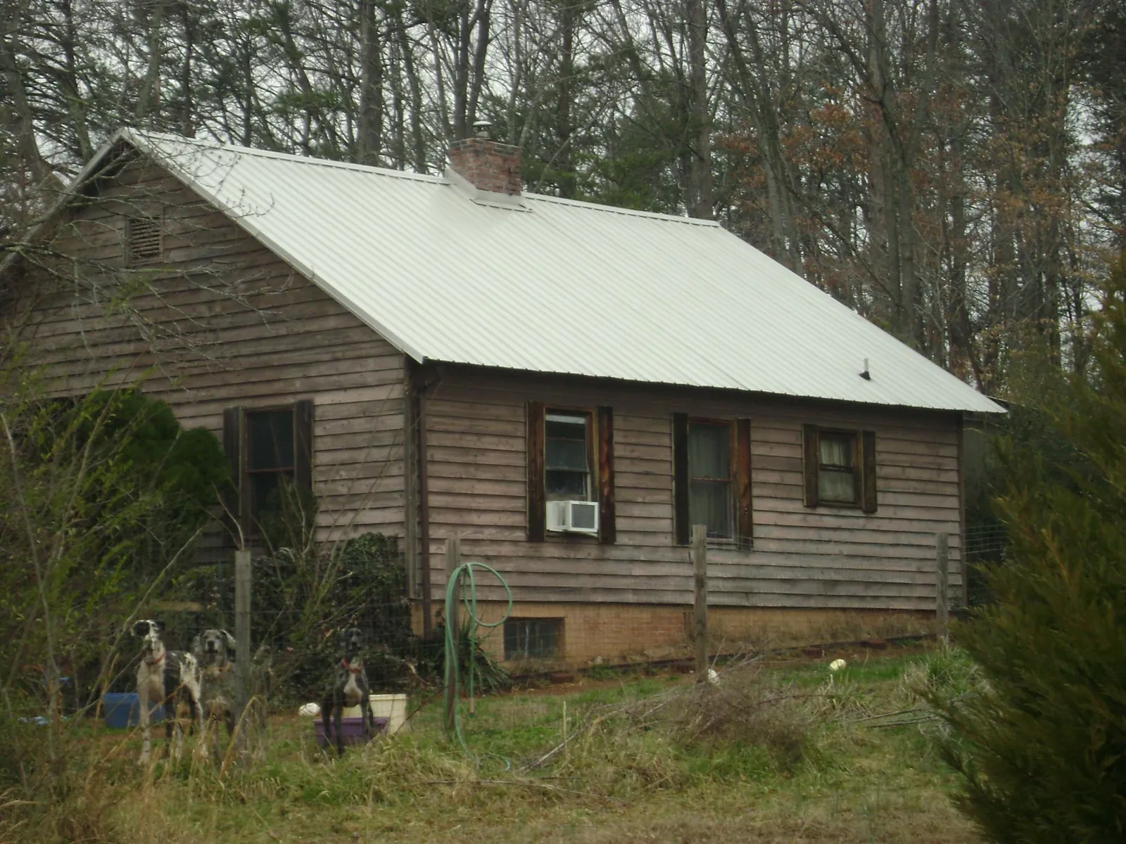 White metal roof on an old wood sided farmhouse, from a Metal Roof Installation job in Hesperia